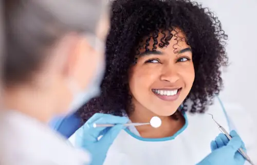 African woman undergoing dental treatment for cometic dentistry